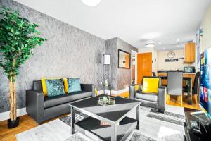 a living room with two couches and a table at Modern Arcadian Center Apartment By Azura Nights in Birmingham