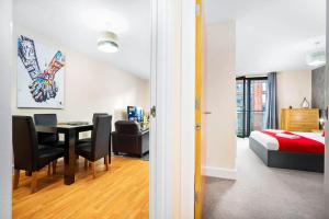 a room with a bedroom and a bed and a table at Modern Arcadian Center Apartment By Azura Nights in Birmingham