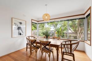 a dining room with a table and chairs and a large window at Lonnie Getaway in Point Lonsdale