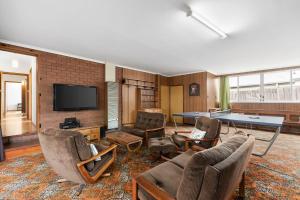 a living room with a ping pong table at Lonnie Getaway in Point Lonsdale