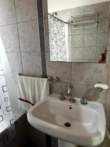 a bathroom with a white sink and a mirror at Sol y Vida in Godoy Cruz