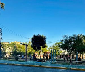 a group of people walking on a city street at Sol y Vida in Godoy Cruz