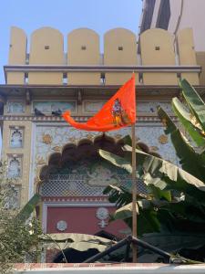 an orange flag flying in front of a building at Sureli Haveli in Jaipur