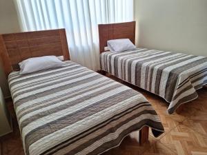 Postel nebo postele na pokoji v ubytování Hospedaje por departamentos UVIMA III