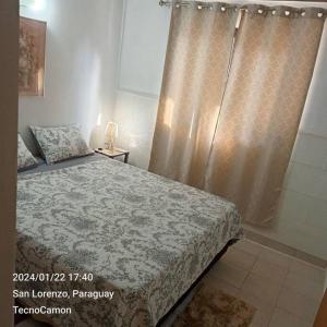 a bedroom with a bed and a shower at Departamento en San Lorenzo in San Lorenzo