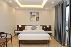 Habitación de hotel con cama, mesa y sillas en An Tín Hotel en Hai Phong