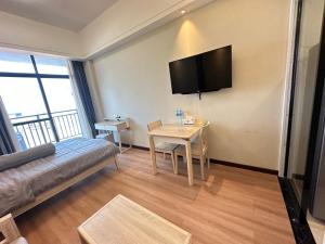 a living room with a couch and a table at Brand New Modern Luxury Studio Apartment at the Heart of Vientiane in Vientiane