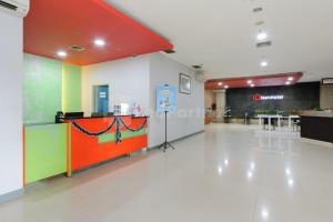 an empty lobby with a colorful counter in a building at NamRoom Hotel Glodok RedPartner in Jakarta