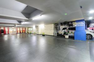 a parking garage with a car parked in it at NamRoom Hotel Glodok RedPartner in Jakarta