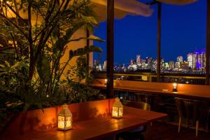 a restaurant with a view of the city at night at Himalaya Cloud Hotel in Tokyo