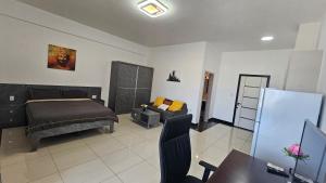 a bedroom with a bed and a couch at Prince Studio Apartments in Willemstad