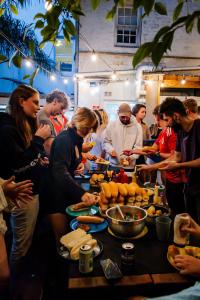 un gruppo di persone che si trovano intorno a un tavolo con cibo di Summer House Kings Cross, Sydney a Sydney