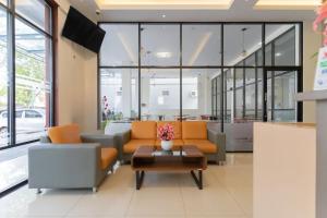 a lobby with two couches and a coffee table at Lexus Hotel Medan in Medan