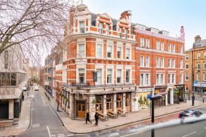 a building on a city street with people walking on the sidewalk at 2 Bedroom in Center of London in London