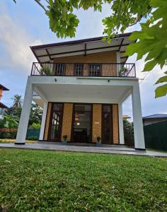 un edificio con balcón en la parte superior de un patio en Syndeo Garden, en Hikkaduwa