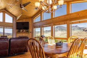 a dining room with a table and chairs and a couch at Wapiti Valley Magic, East Yellowstone in Wapiti