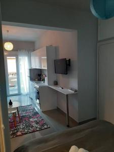 um quarto com uma cozinha com uma mesa e uma televisão em P.S. Attiki em Atenas