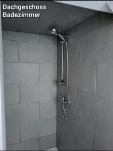 a shower with a shower head in a bathroom at Gemeinschaft Ferienhaus in Bad Neuenahr-Ahrweiler