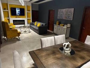 a living room with a table and a couch at Payes Home in Siguatepeque