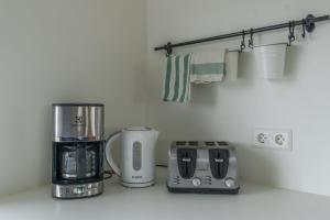 a kitchen with a coffee maker and a toaster at Vogar Travel Service in Myvatn