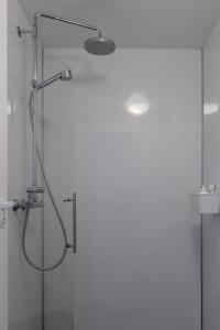 a shower in a bathroom with a glass door at Vogar Travel Service in Myvatn