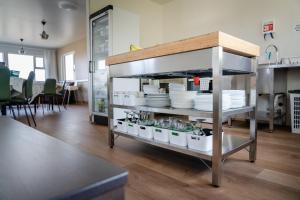a kitchen with plates and dishes on a shelf at Vogar Travel Service in Myvatn