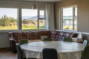 a living room with a table and a couch at Vogar Travel Service in Myvatn