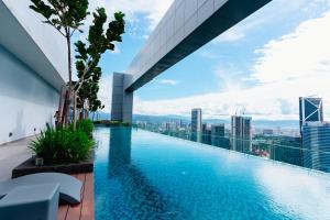 a swimming pool on the roof of a building with a view at Royce KLCC Kuala Lumpur City Centre by Dormeo Destinations in Kuala Lumpur