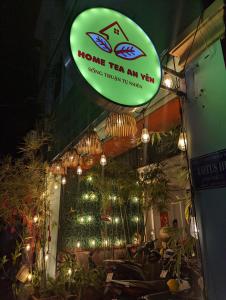 a sign that says home tea an yard with lights at Home Tea An Yên Dorm in Ho Chi Minh City
