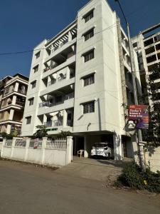 an apartment building with a car parked in front of it at Blissful stays in Pune