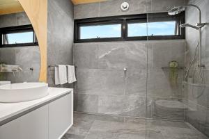 a bathroom with a sink and a glass shower at Tasman Holiday Parks - St Helens in St Helens