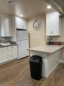 a kitchen with a counter and a white refrigerator at New! Cozy Gated 3BR, 2BA Vacation Home in Rosemead