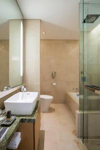 a bathroom with a sink and a toilet and a shower at Marriott Executive Apartment Seoul in Seoul