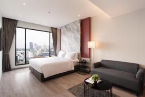 Postel nebo postele na pokoji v ubytování Thaya Hotel Bangkok + 37 fotografií
