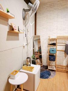 a room with a white refrigerator and a table at 207:Homely room in apartment Near BTS Kasetsart U. in Bangkok