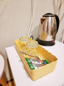 a package of cheese and a tea kettle on a table at 207:Homely room in apartment Near BTS Kasetsart U. in Bangkok