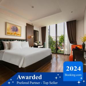 a hotel room with a bed and a balcony at Bendecir Hotel & Spa in Hanoi