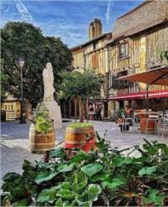 un groupe de plantes devant un bâtiment dans l'établissement Le Vin Quatre, à Bergerac