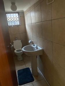 a bathroom with a sink and a toilet at 4 Rees Street in East London
