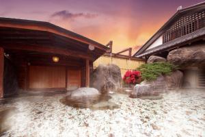 a building with a water fountain in front of it at Beautiful Japanese Garden Kagetsu in Fuefuki