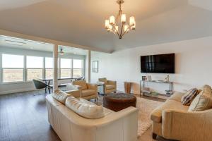 a living room with two couches and a tv at Waterfront NOLA Gem with Boat Dock and Lift in Venetian Isles