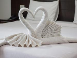 two swansrendered to look like they are making a heart at Nirwana Resort in Habarana