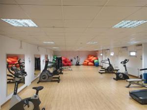 a gym with a row of exercise bikes and exercise balls at Birlik in Tengiz