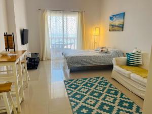 a living room with two beds and a couch at Ocean Breeze in Ras al Khaimah