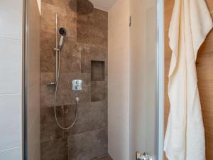 a bathroom with a shower with a shower curtain at Ferienwohnung Emmerenzia in Söll