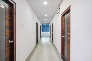 a hallway with two doors and a row of corridors at FabHotel Grand Broholic in Hyderabad