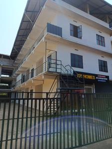 a building with a fence in front of it at KK Residency in Perintalmanna