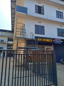 a building with a metal staircase in front of a building at KK Residency in Perintalmanna