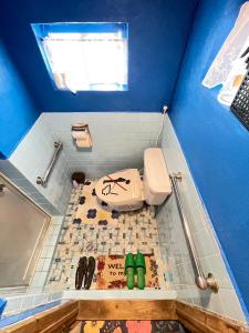 bagno con servizi igienici in una camera blu di 海人の宿 口福丸 KoufukuMaru a Yabiku