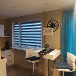 a kitchen with a table and chairs and a window at Trinitix apartment in Tapa